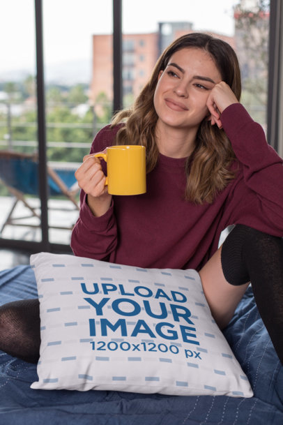Pillow Mockup Featuring a Gorgeous Young Woman Holding a Coffee Mug at Home