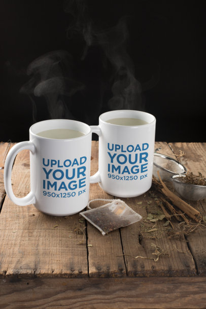 Mockup of Two Mugs with Steaming Water Surrounded by Tea Leaves 23902