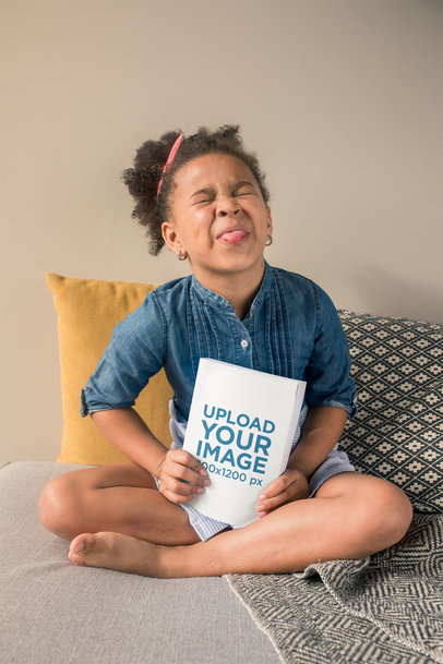 Book Mockup Featuring a Cute Little Girl Sticking Her Tongue Out 23722