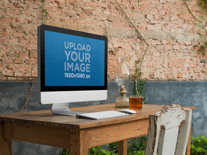 iMac on Top of a Wooden Desk at a Creative Office Mockup