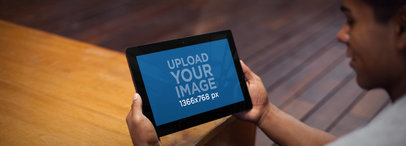 Mockup of a Young Man Using a Windows Surface Tablet