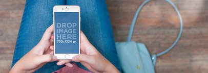 Mockup of a Young Woman Using an iPhone 6 in a Waiting Room
