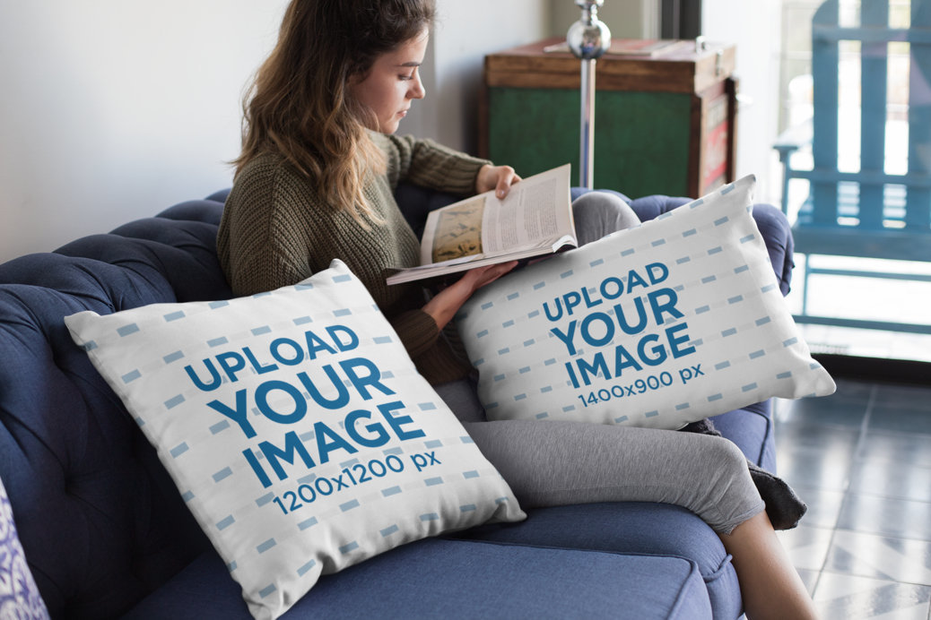 Mockup of a Woman Reading Next to Two Throw Pillows