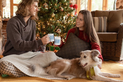 Mug Mockup of a Cute Couple Drinking Hot Cocoa by a Christmas Tree