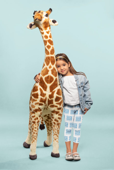 Leggings Mockup of a Cute Little Girl Hugging a Plush Giraffe