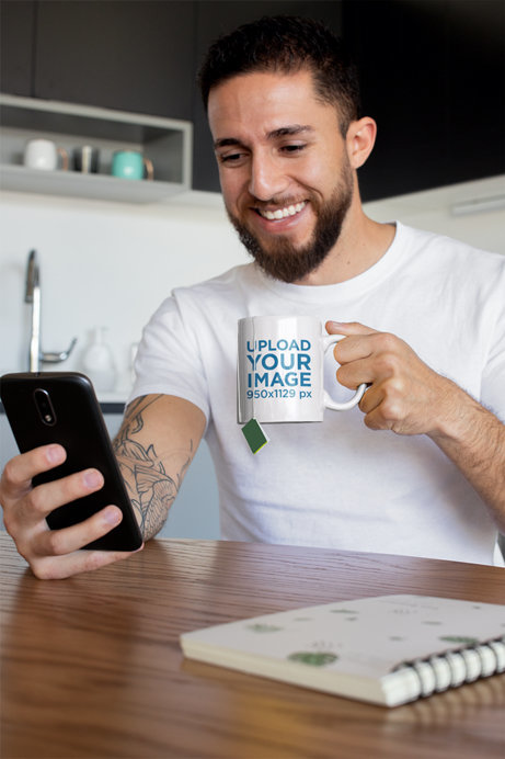 Mug Mockup of a Tattooed Man Having Some Tea at Home