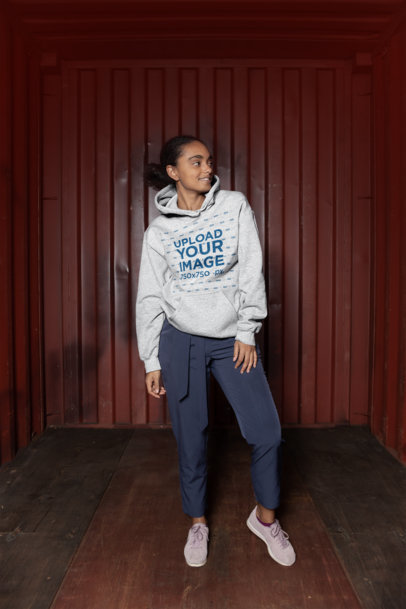 Heathered Pullover Hoodie Mockup Featuring an Urban Woman Posing 