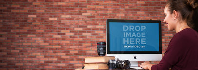 Mockup of a Young Professional Woman at a Photo Studio Using an iMac