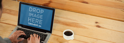 Man at the Office Having Coffee and Working on his Macbook Mockup