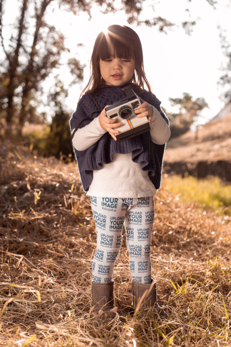 Leggings Mockup of a Little Girl Holding a Polaroid at the Woods