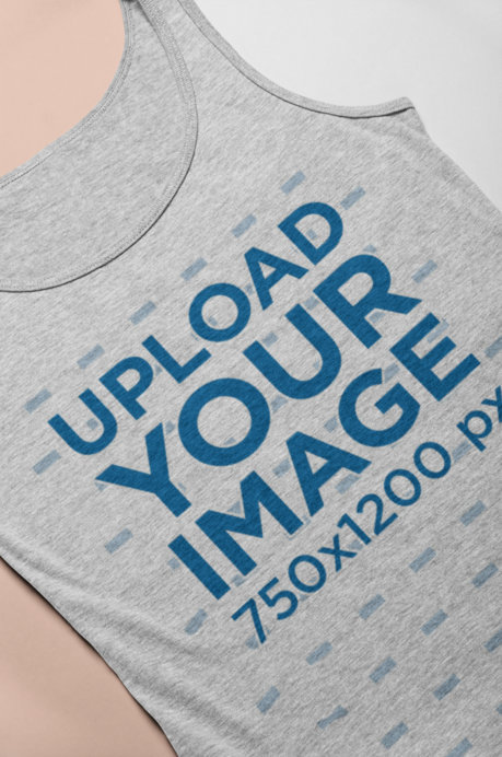 Mockup of a Heathered Tank Top Lying on a Bicolor Surface