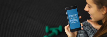 iPhone Mockup of a Young Woman at the Gym Using iPhone 6