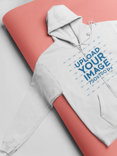 Mockup of a Full Zip Hoodie Lying Over a Rolled Cardboard 24362