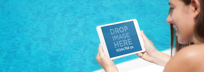 Tablet Mockup of a Young Woman Lounging by the Pool Using an iPad