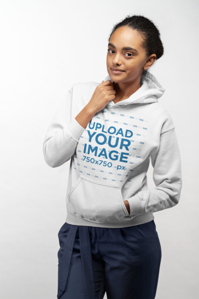 Mockup of a Woman Wearing a Pullover Hoodie in a Studio