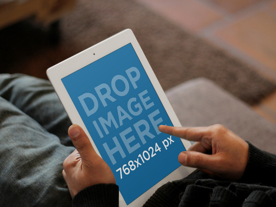 Mockup of a White iPad Featuring a Person Working in Bed