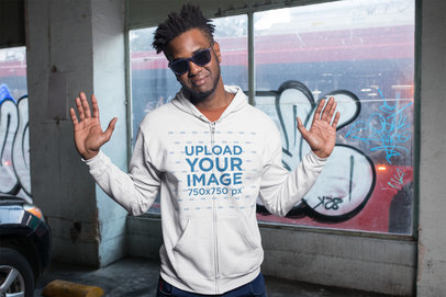 Mockup of a Chill Man Wearing a Zip Up Hoodie in a Parking Lot