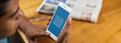 iPhone Mockup of a Young Man Reading the News on his iPhone 6