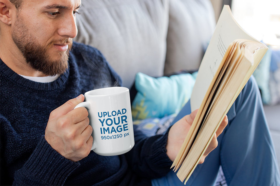 Mug Mockup of a Bearded Man Drinking Coffee and Reading a Book