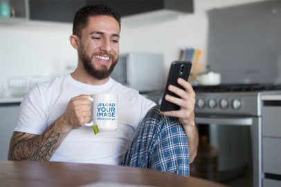 15 oz Ceramic Mug Mockup of a Bearded and Tattooed Man Drinking Tea in the Kitchen