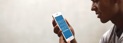 Mockup of a Young Man Holding an iPhone 6 Over a White Background 