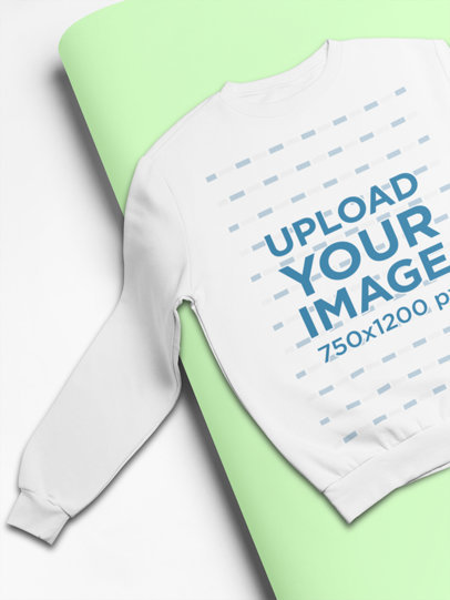 Sweatshirt Mockup Featuring a Rolled Pasteboard Over Another 24357
