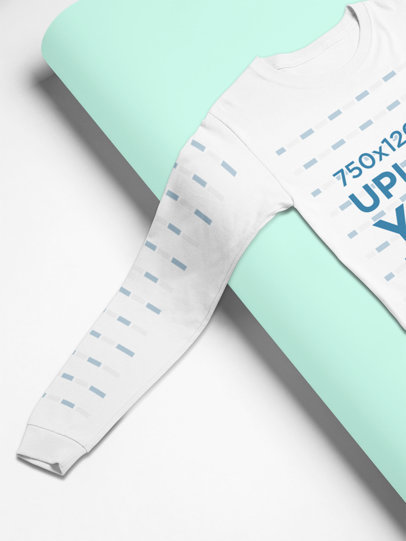 Mockup of a Long Sleeve Tee Lying Flat on a Cardboard 24360