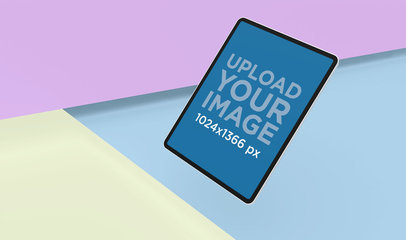 Mockup Featuring an iPad Pro Floating over a Colored Background