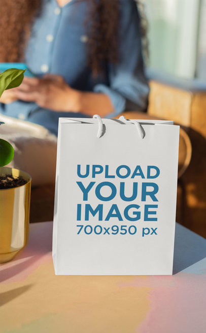 Mockup of a Gift Bag Standing on a Table