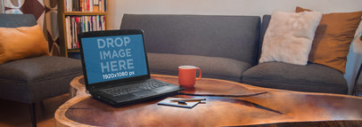 Mockup of a Black Laptop On Top of a Wooden Coffee Table 