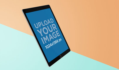 Mockup of a Slightly Angled iPad Pro Floating Over a Colored Surface 24476