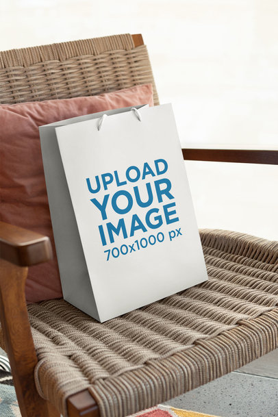 Mockup of a Gift Bag Placed upon a Weaved Chair 24035