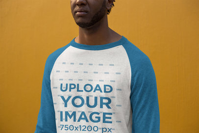 Long Sleeve Raglan Tee Mockup of a Man Standing Against a Solid Color Wall 24116