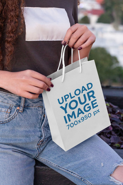 Gift Bag Mockup Featuring a Woman with Curly Hair