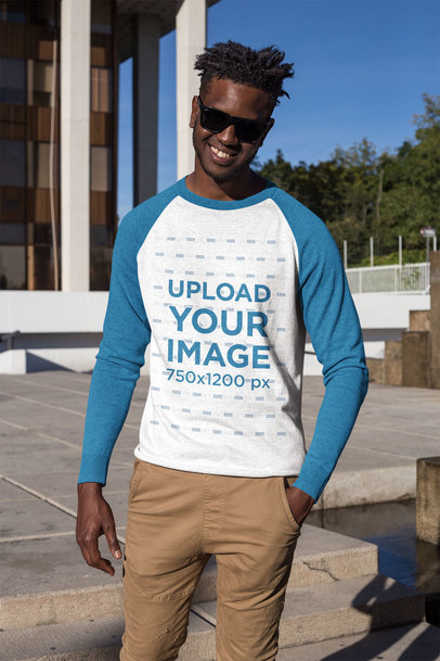 Mockup of a Smiling Man Wearing a Heathered Raglan Long Sleeve Tee