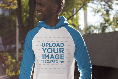 Mockup of a Smiling Man Wearing a Raglan Hoodie