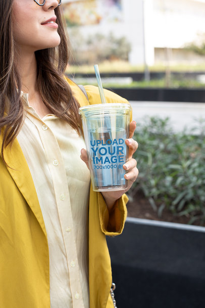 Tumbler Mockup Featuring a Woman Wearing a Yellow Coat 24412