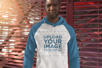 Mockup of a Serious Man Wearing a Raglan Pullover Hoodie