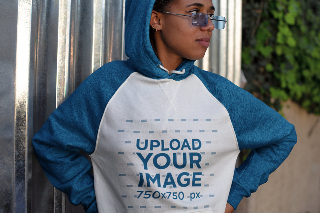 Raglan Hoodie Mockup Featuring a Woman with Glasses Looking Away