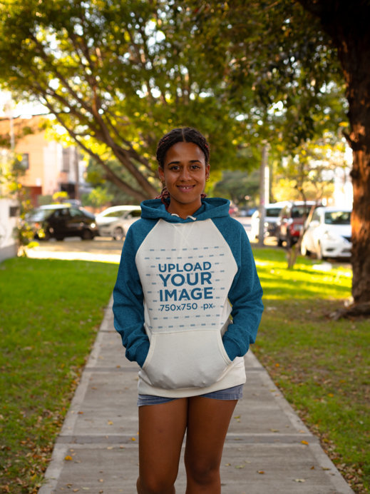 Raglan Hoodie Mockup of a Smiling Woman at a Park