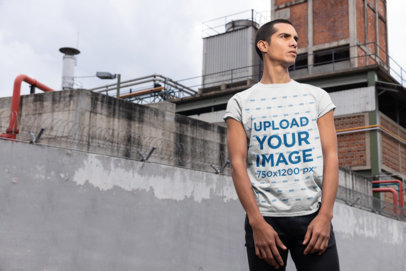 Mockup of a Man Wearing a Tee and Standing in an Industrial Scenario