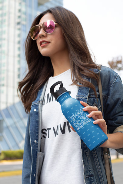 Mockup of a Fashionable Woman Holding an Aluminium Water Bottle