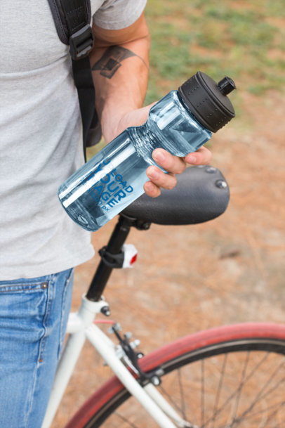 Water Bottle Mockup Featuring a Man with a Tattoo
