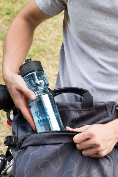 Mockup of a Man Putting Away His Sports Bottle