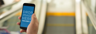  Mockup of a Woman Using a Motorola Moto X at the Metro a5181wide