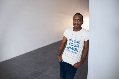 T-Shirt Mockup of a Man Standing in a Hallway