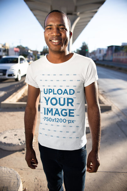 T-Shirt Mockup of a Smiling Man Under a Bridge