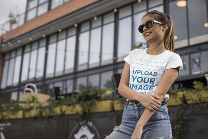 Tee Mockup of a Smiling Woman in the City Wearing Trendy Sunglasses
