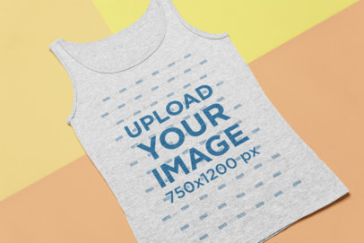 Flat Lay Mockup of a Heathered Tank Top on a Tricolor Surface