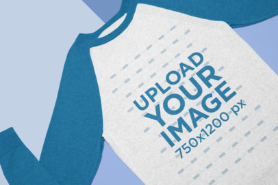 Flat Lay Mockup of a Heathered Raglan Sweatshirt over a Custom Surface